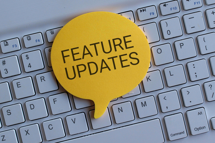 Top view image of keyboard and speech bubble with text FEATURE UPDATES